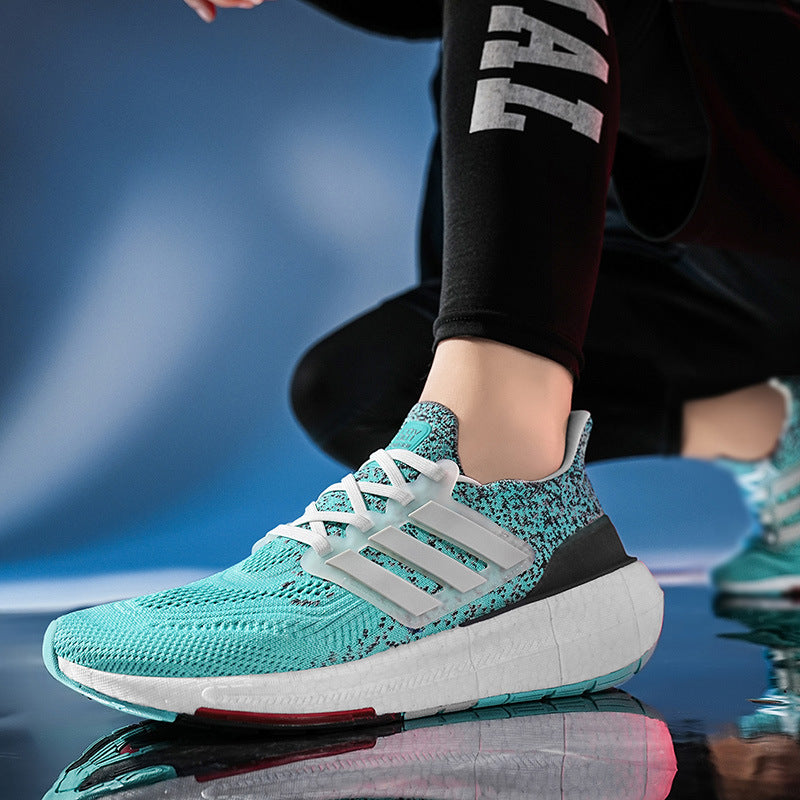 Teal running shoe with white laces on a reflective surface
